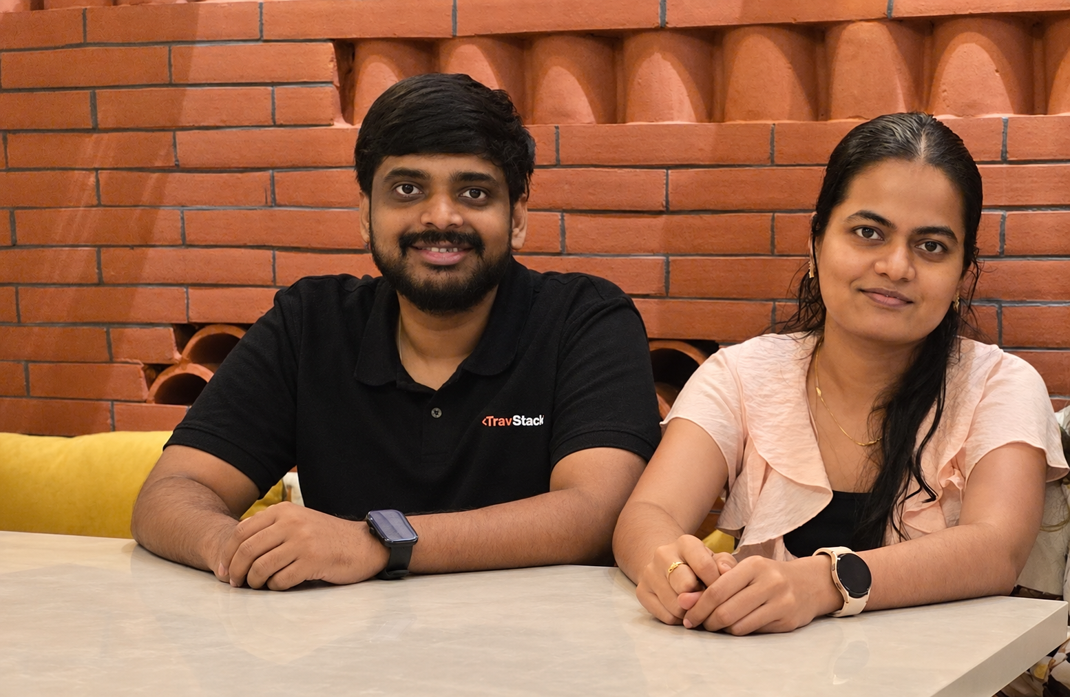 SuperAI co-founders Sai Santhosh Kalangi and Mounika Pothineni seated together at a table